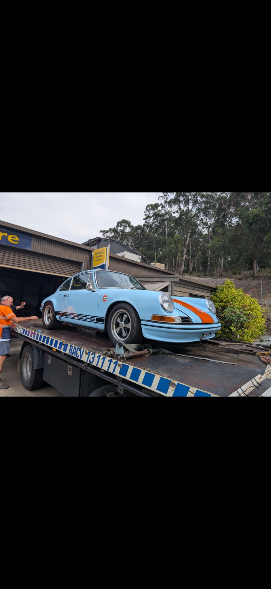 Classic Porsche 911 loaded onto a recovery truck